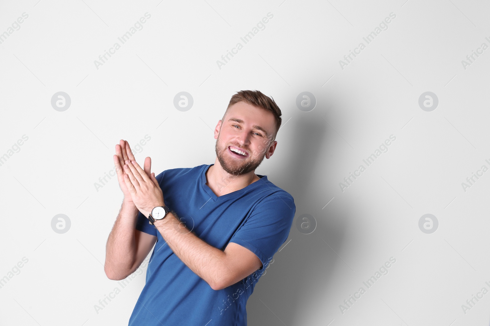 Photo of Portrait of handsome laughing man on white background