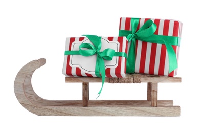 Photo of Wooden sleigh with gift boxes isolated on white. Christmas holiday decor