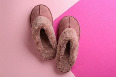 Pair of stylish soft slippers on color background, flat lay