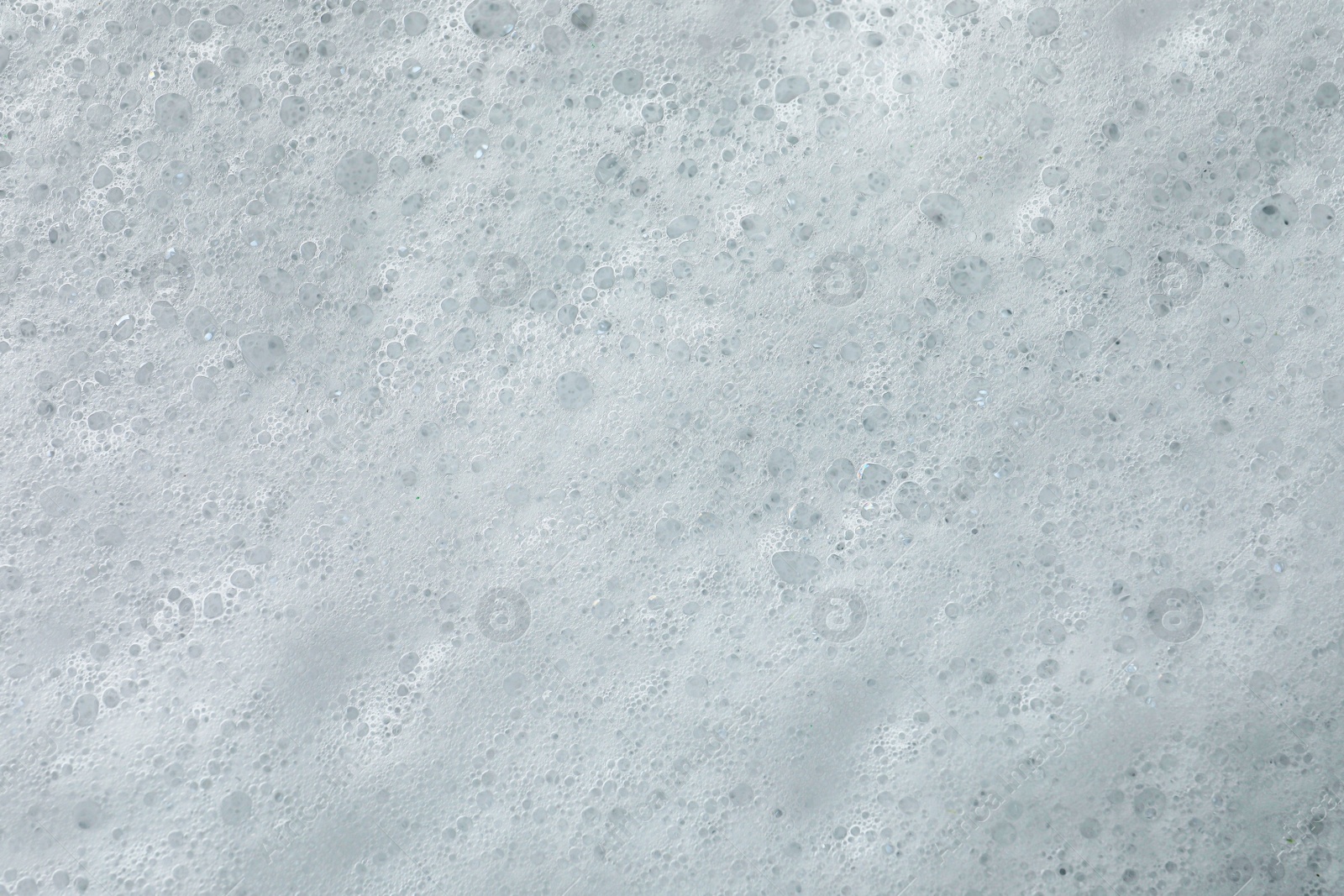 Photo of Fluffy soap foam as background, top view