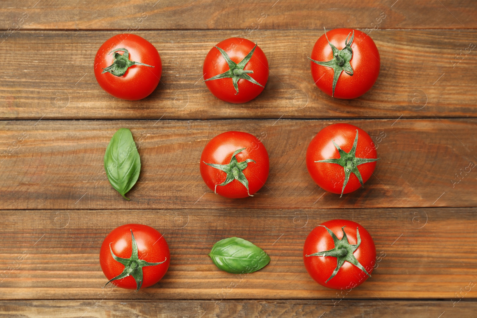 Photo of Flat lay composition with ripe tomatoes on wooden background