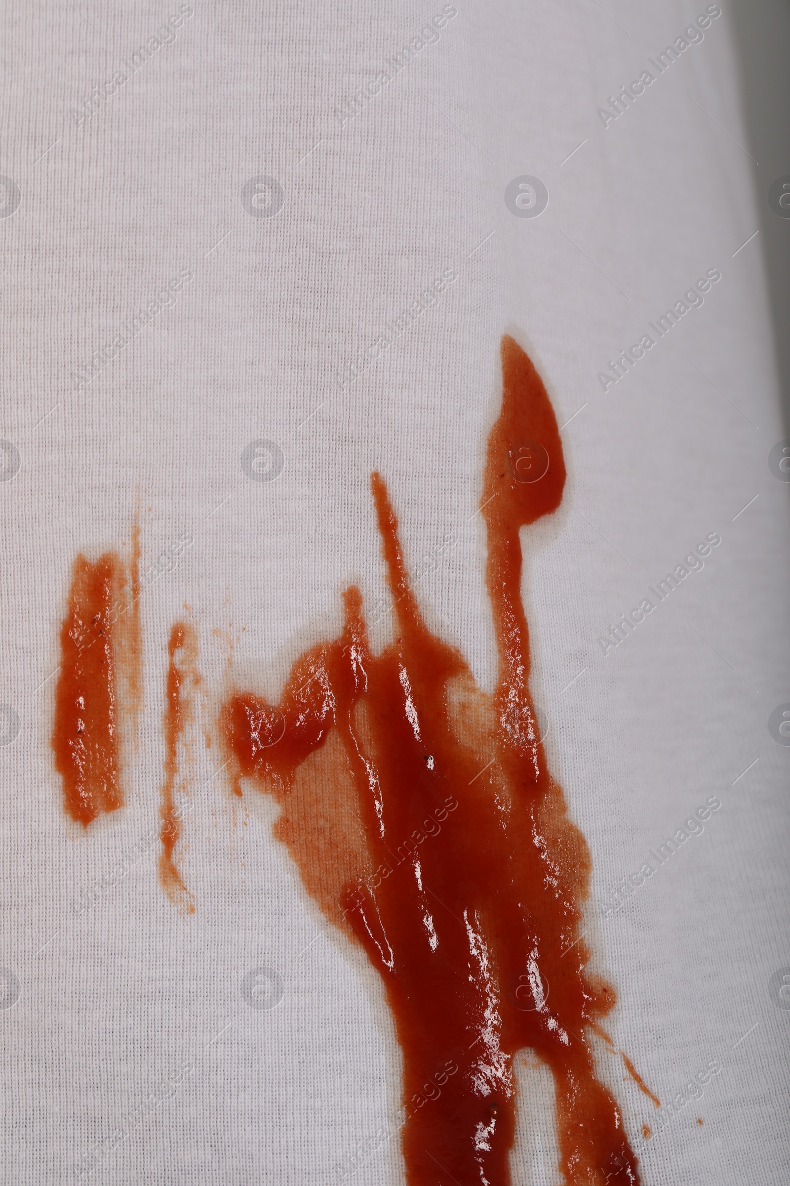 Photo of White shirt with stain of sauce, closeup