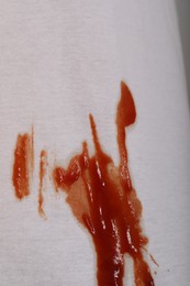 Photo of White shirt with stain of sauce, closeup