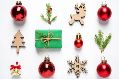 Flat lay composition with Christmas gift and festive decor on white background