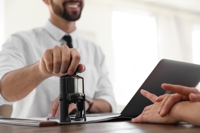 Male notary working with client in office, closeup