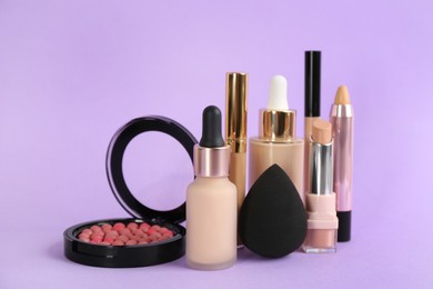 Photo of Foundation makeup products on violet background. Decorative cosmetics