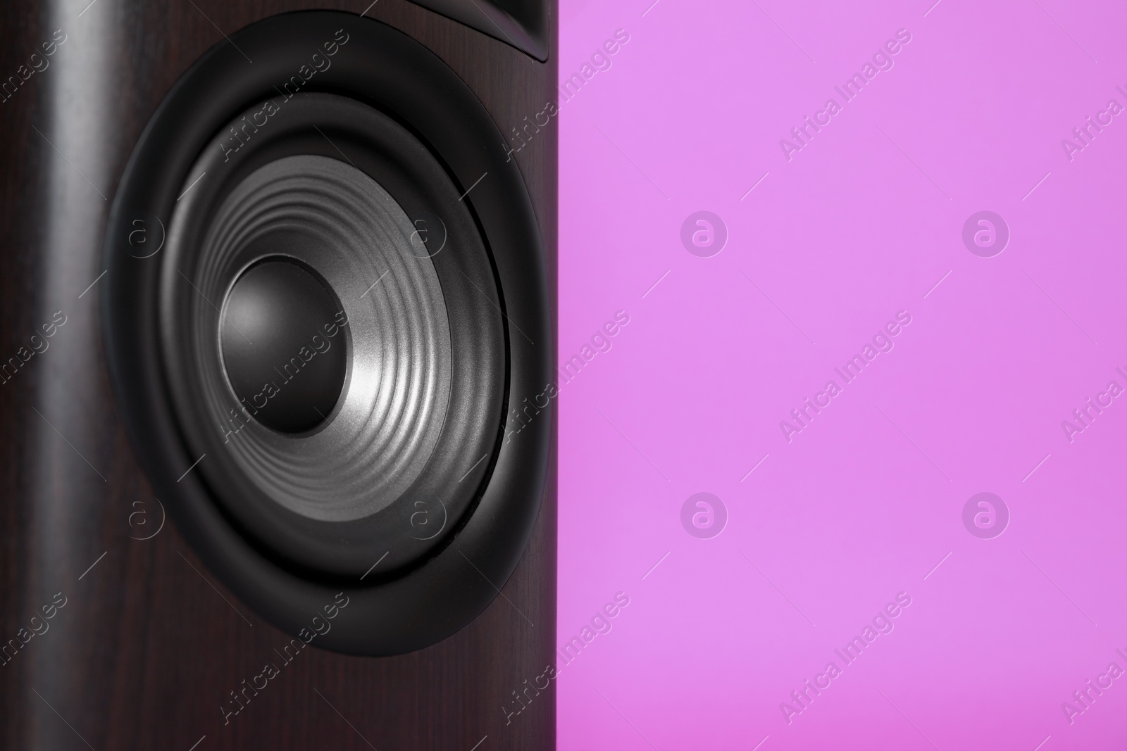 Photo of One wooden sound speaker on violet background, closeup. Space for text