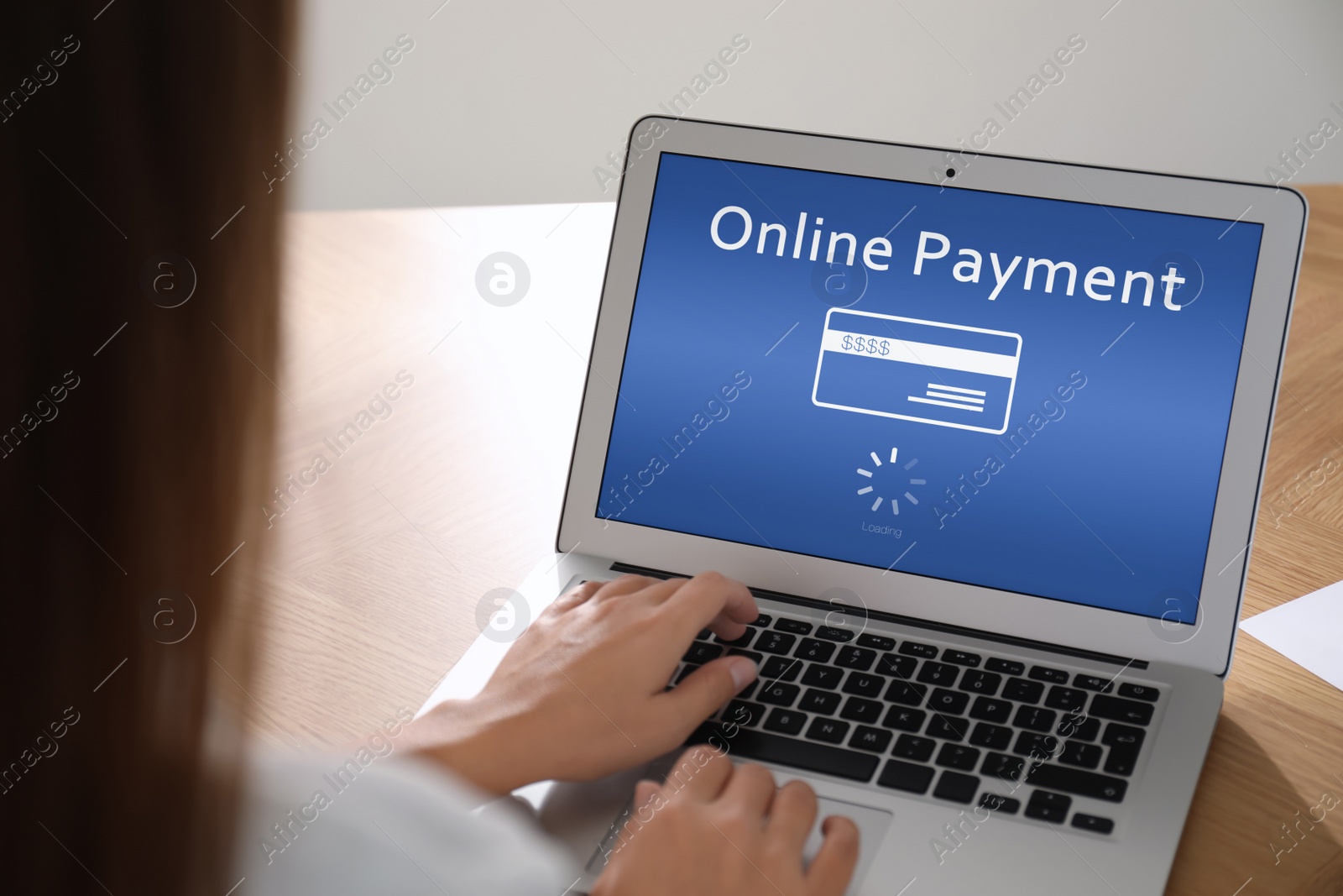 Image of Woman using laptop for online payment at table, closeup