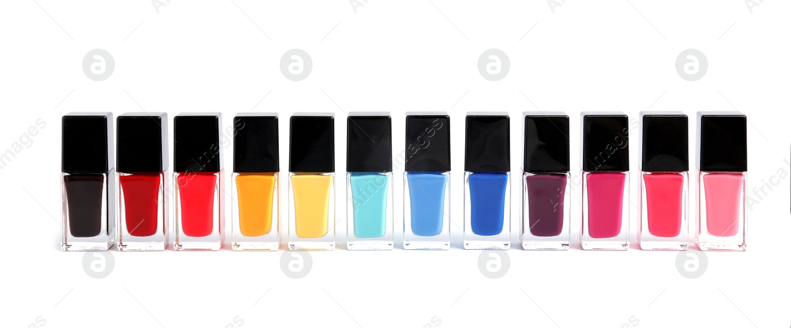 Photo of Bottles of nail polish on white background