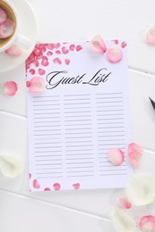 Guest list, coffee and petals on white wooden table, flat lay. Space for text