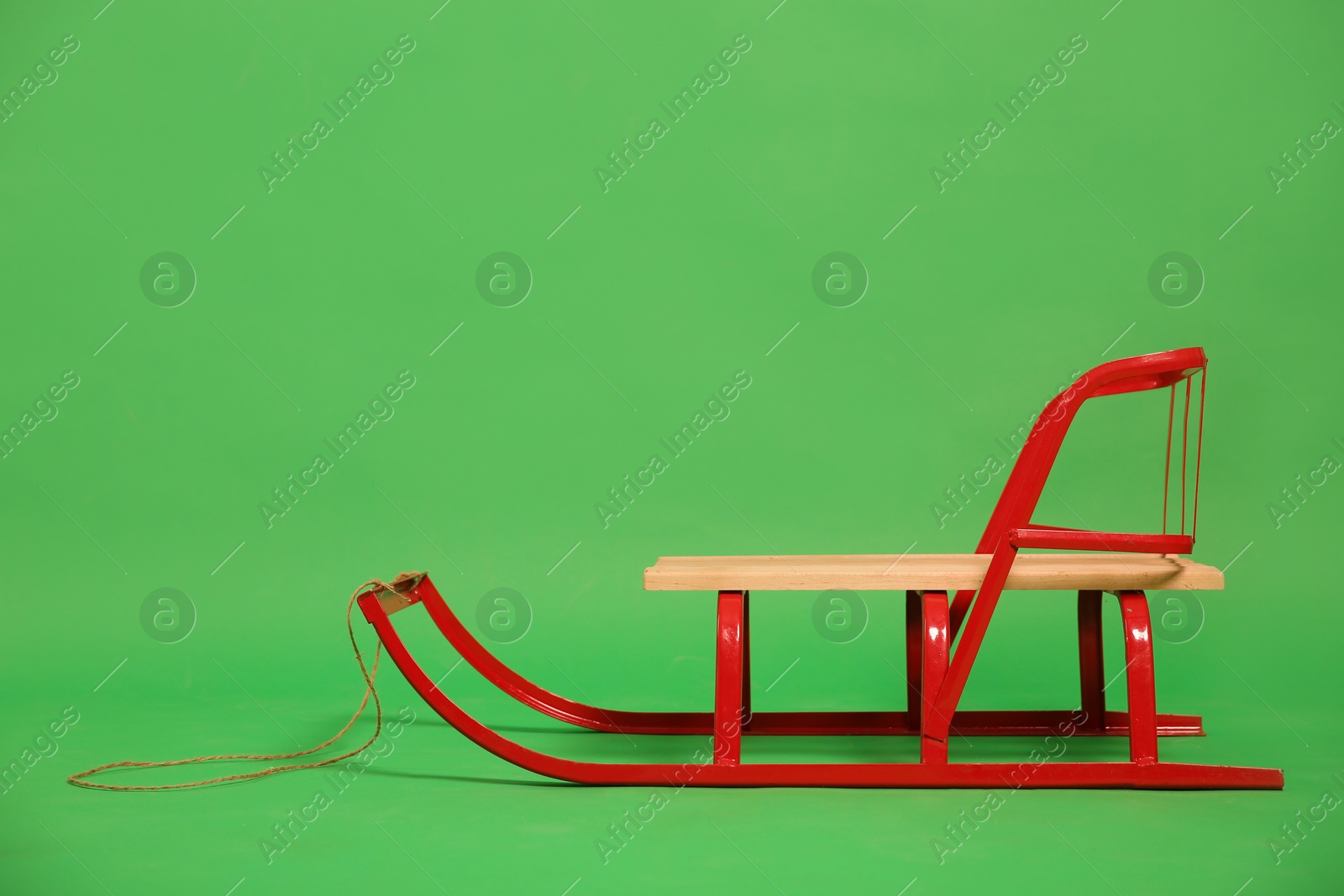 Photo of Empty sleigh on green background. Winter activity