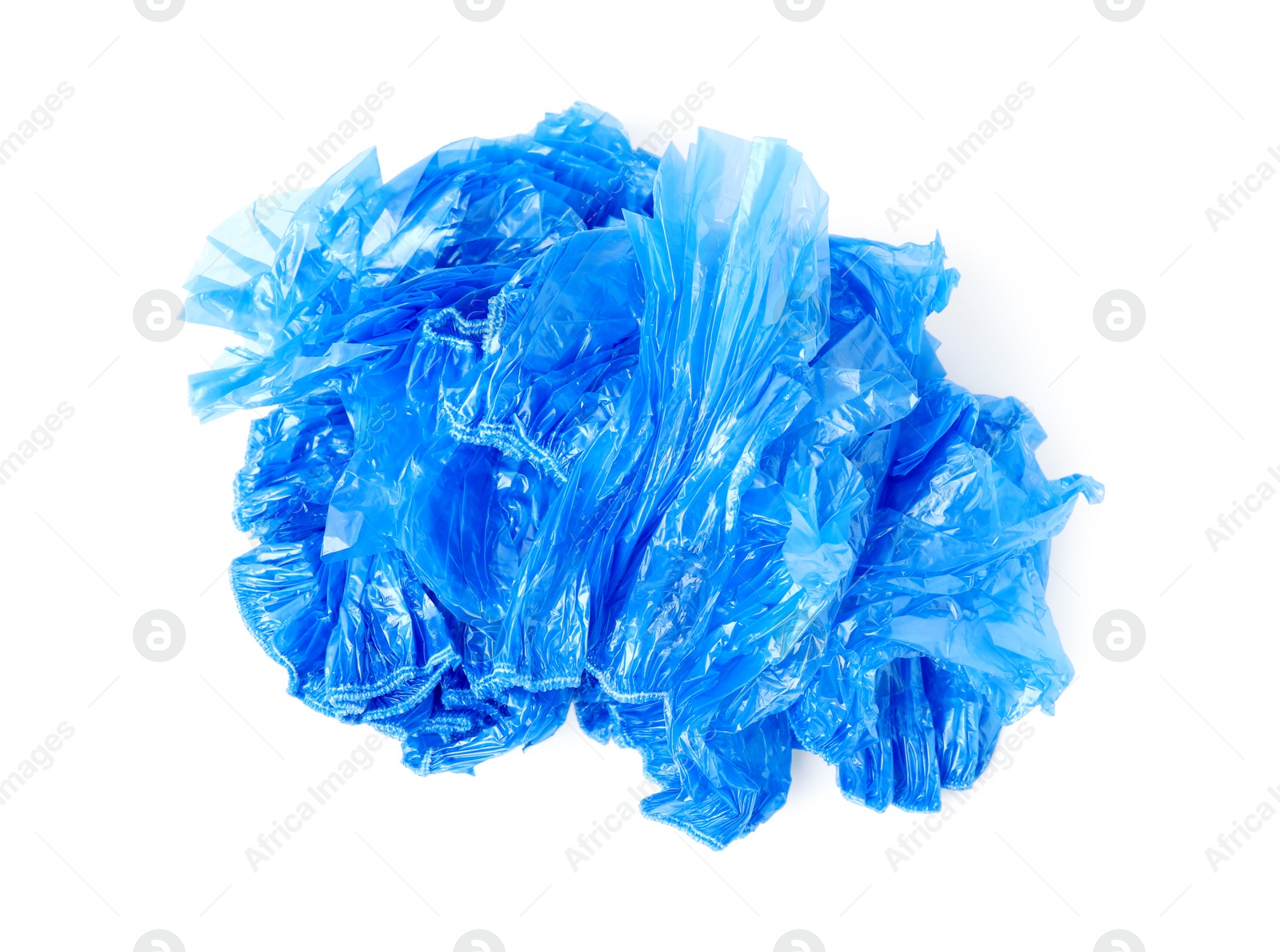 Photo of Pile of many blue medical shoe covers isolated on white, top view