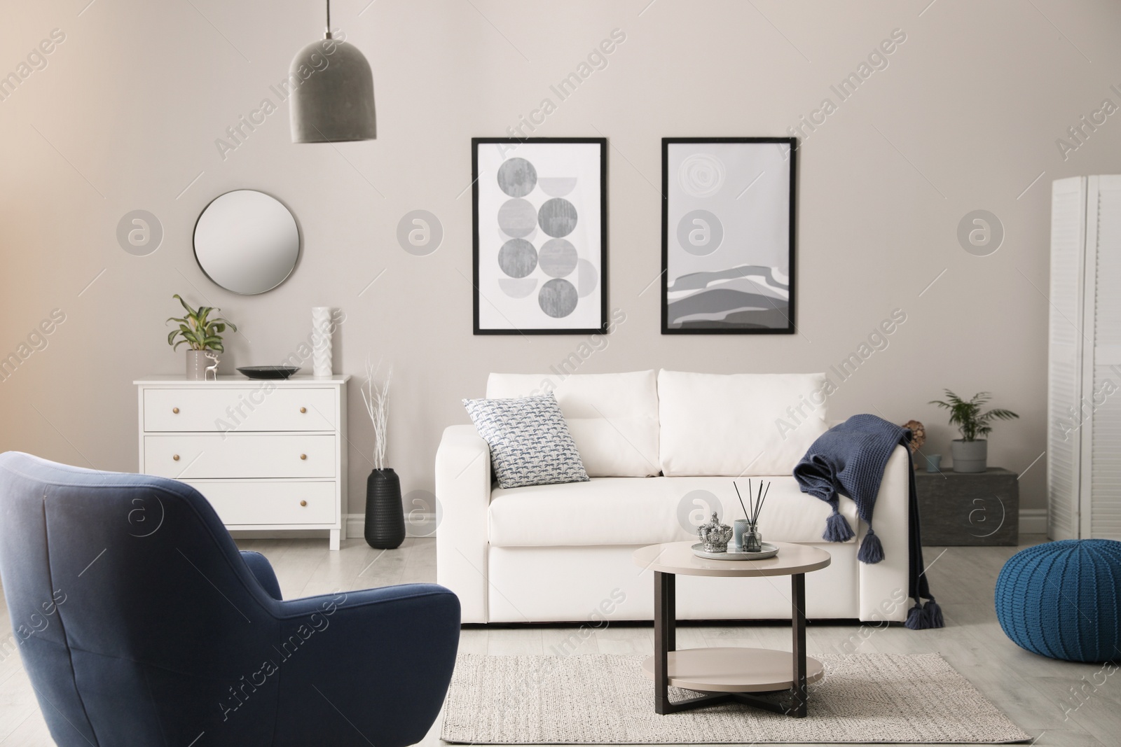 Photo of Stylish living room interior with white sofa, armchair and small coffee table