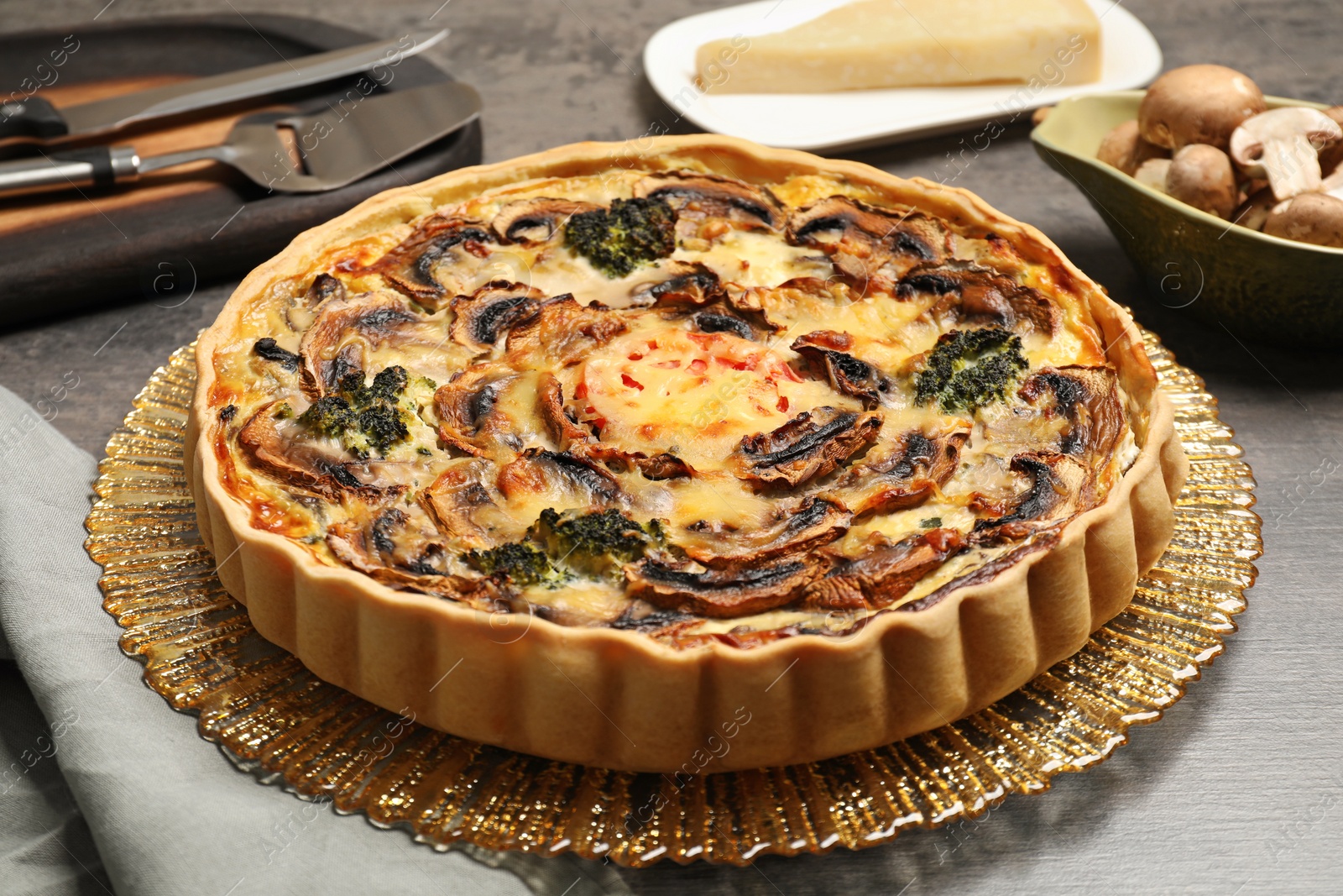 Photo of Delicious quiche with mushrooms on table, closeup