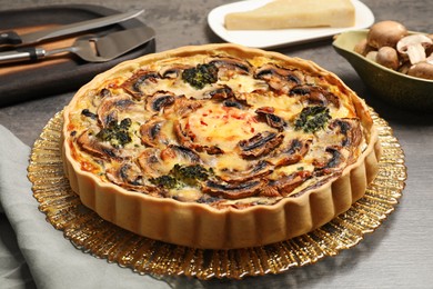 Delicious quiche with mushrooms on table, closeup