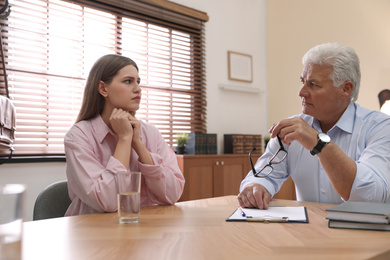 Photo of Professional psychotherapist working with patient in office