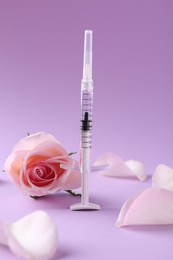 Photo of Cosmetology. Medical syringe, rose flower and petals on pink background