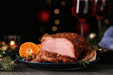 Photo of Plate with homemade Christmas ham on dark table