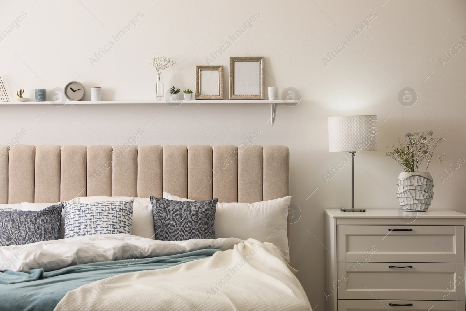 Photo of Comfortable bed with pillows in room. Stylish interior design