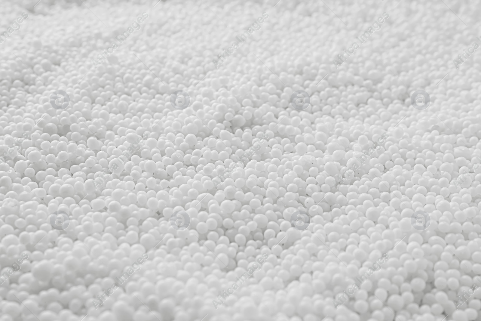 Photo of Pellets of ammonium nitrate as background, closeup. Mineral fertilizer