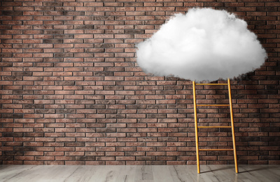 Image of Wooden ladder with cloud near brick wall, space for text . Conceptual design 