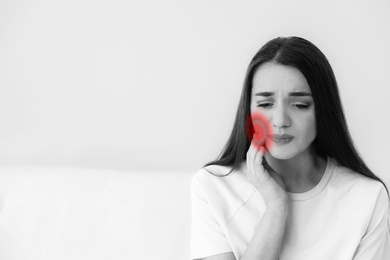 Image of Young woman suffering from toothache at home. Space for text