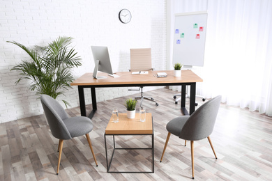 Photo of Interior of modern office with table, chairs and computer