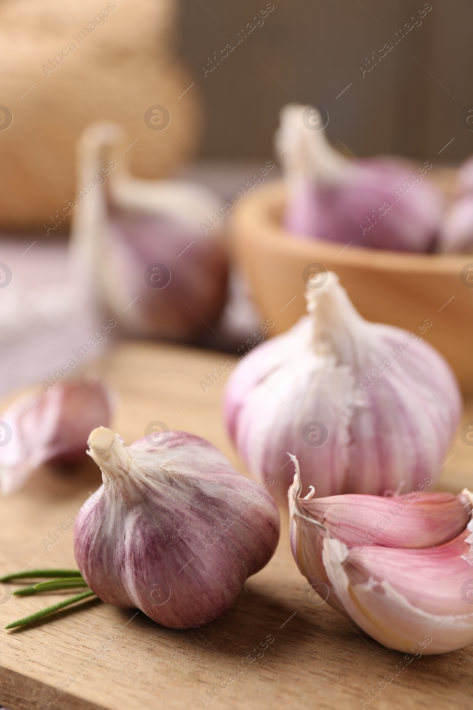 Photo of Bulbs and cloves of fresh garlic on table, closeup