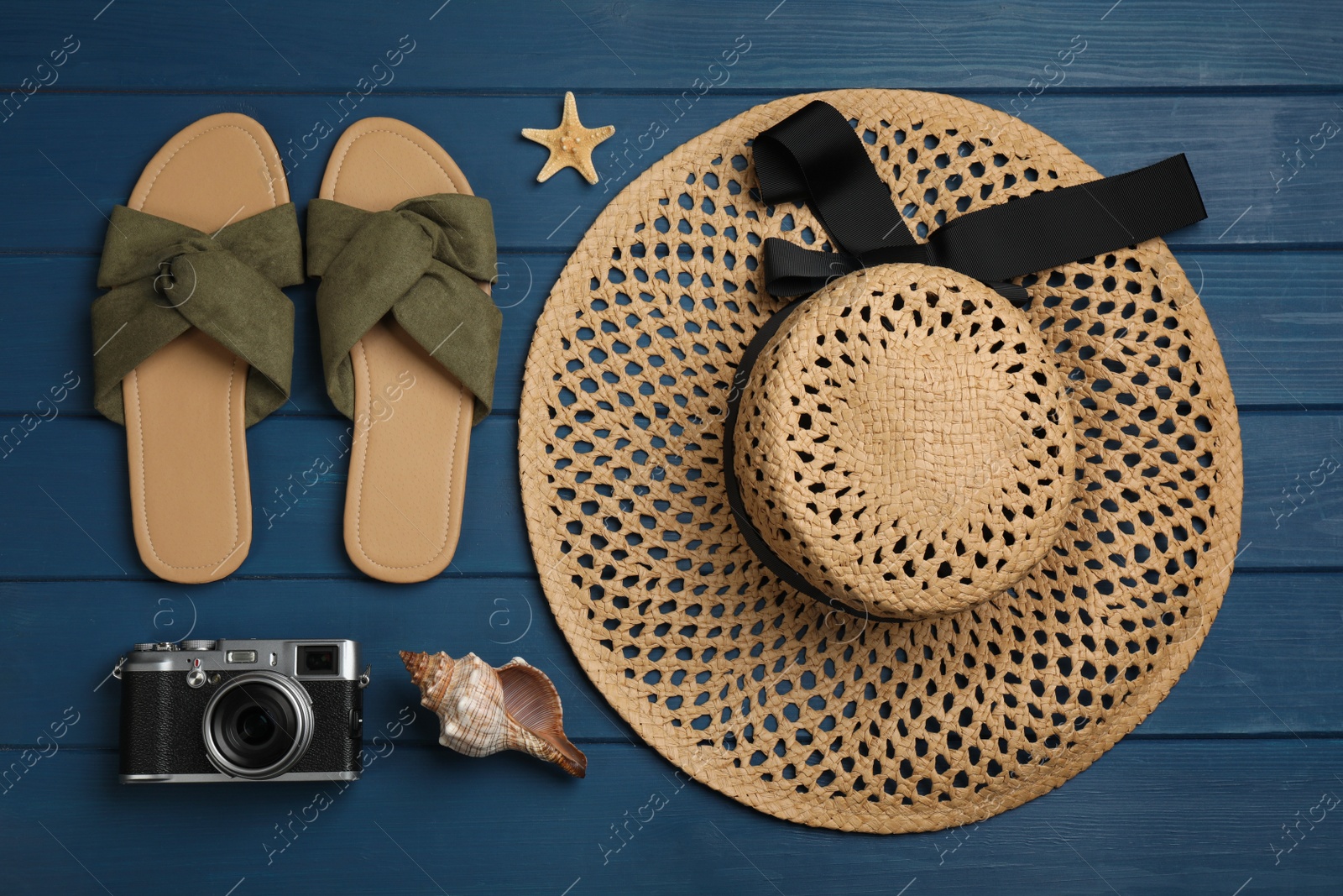 Photo of Flat lay composition with beach objects on blue wooden background