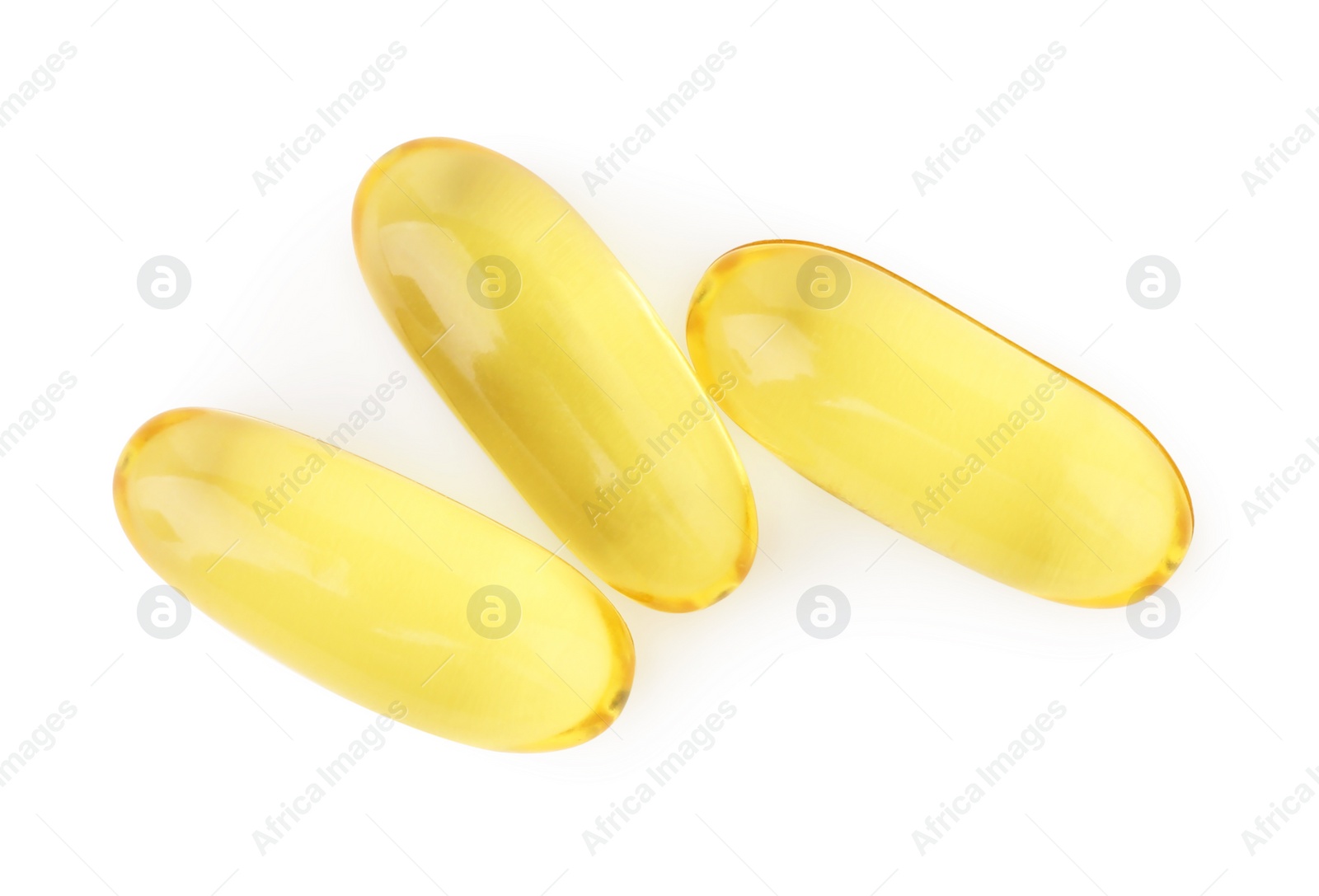 Photo of Many yellow vitamin capsules isolated on white, top view