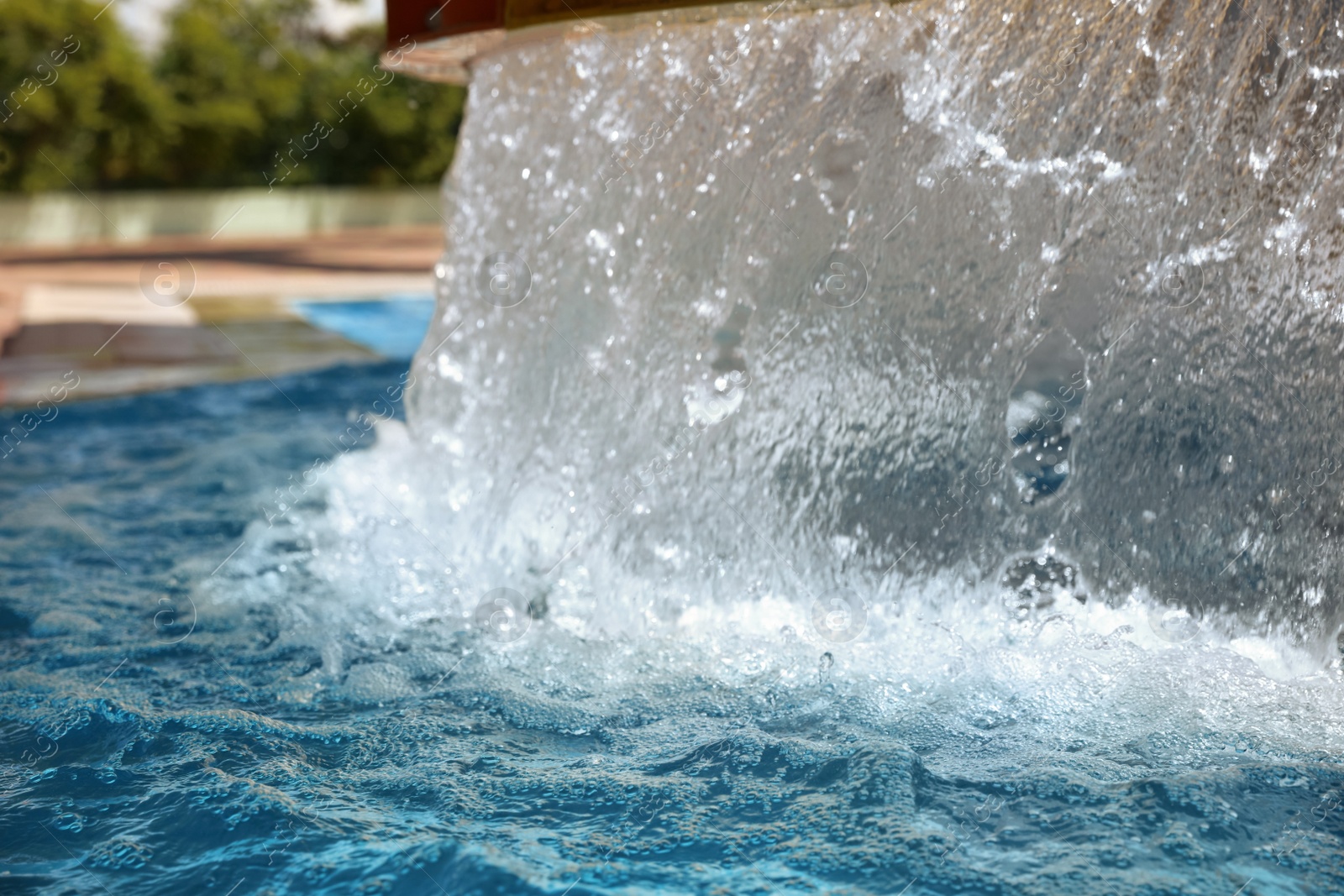 Photo of Outdoor swimming pool with clear water on sunny day. Summer vacation