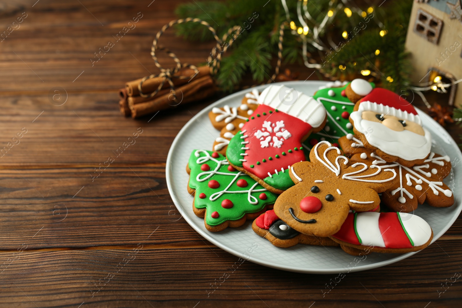 Photo of Different tasty Christmas cookies on wooden table, closeup. Space for text