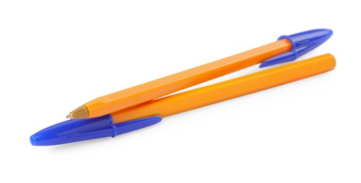 New orange plastic pens isolated on white