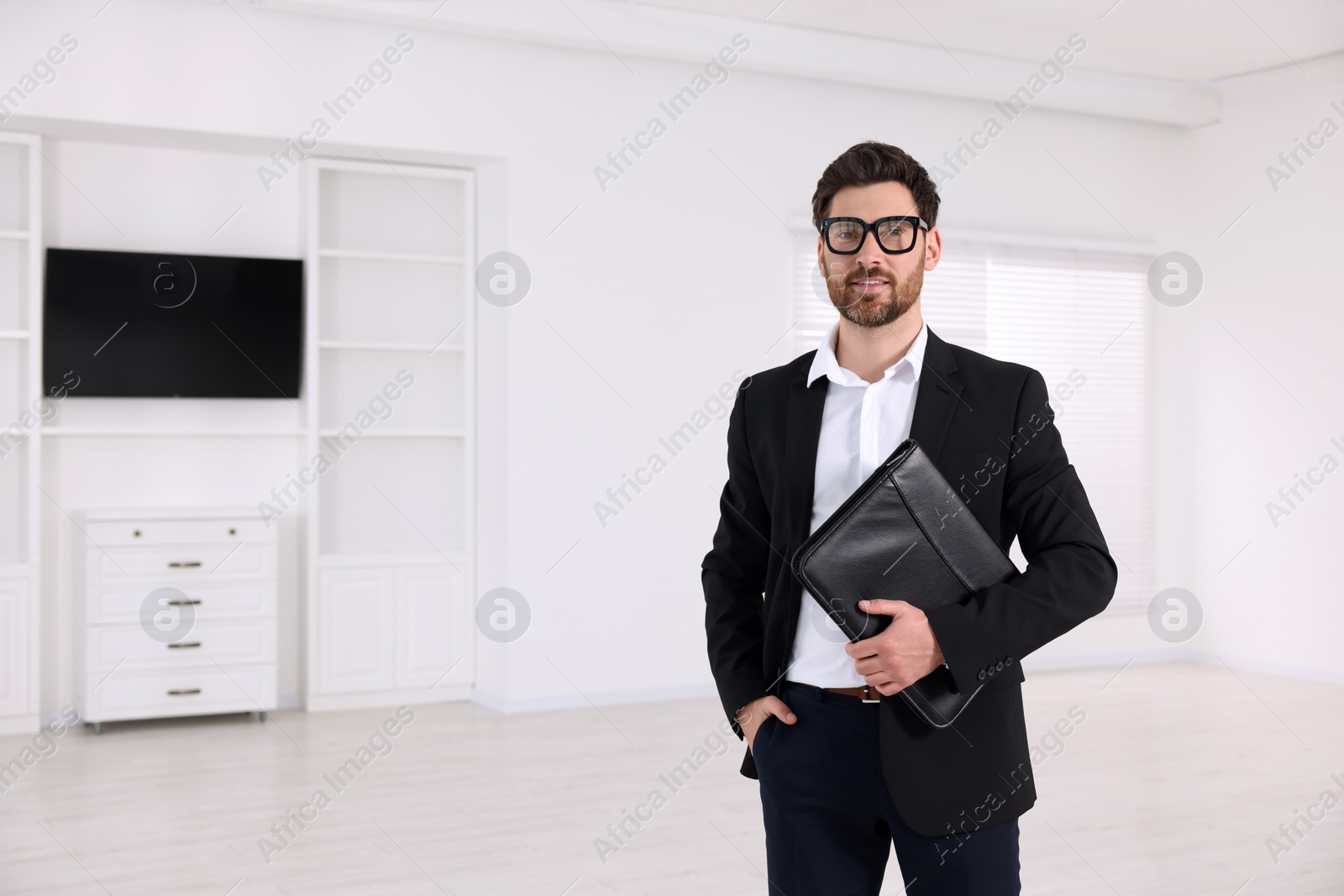 Photo of Real estate agent with leather portfolio in new apartment