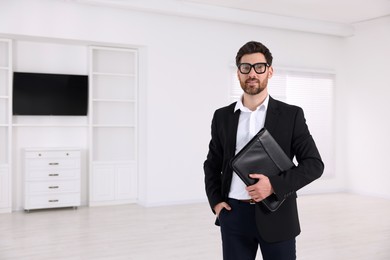 Photo of Real estate agent with leather portfolio in new apartment