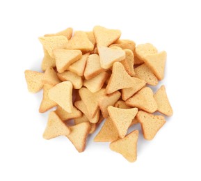 Pile of delicious crispy rusks on white background, top view