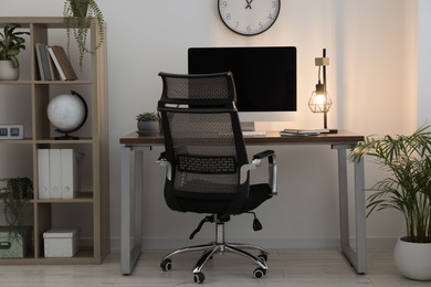 Photo of Workspace with desk, chair and computer at home