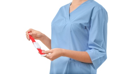 Photo of Female doctor holding tourniquet on white background, closeup. Medical object