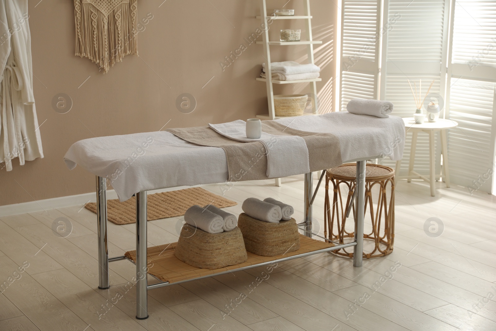 Photo of Stylish spa salon interior with massage table