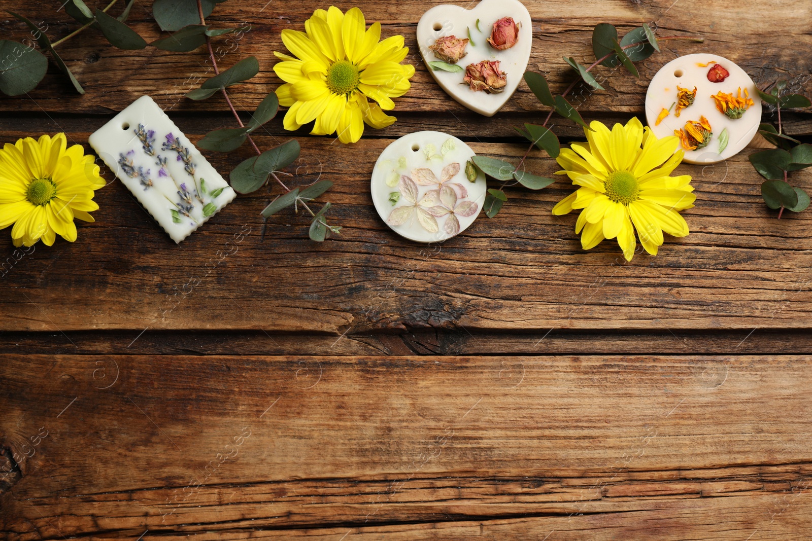 Photo of Flat lay composition with scented sachets on wooden table, space for text