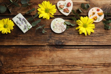 Flat lay composition with scented sachets on wooden table, space for text