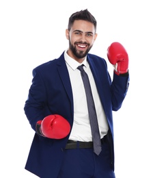 Photo of Happy young businessman with boxing gloves celebrating victory on white background