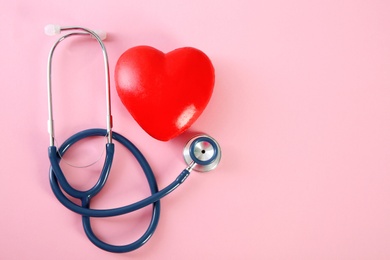 Photo of Flat lay composition with red heart model and stethoscope on color background, top view