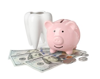 Photo of Ceramic model of tooth, piggy bank and money on white background. Expensive treatment