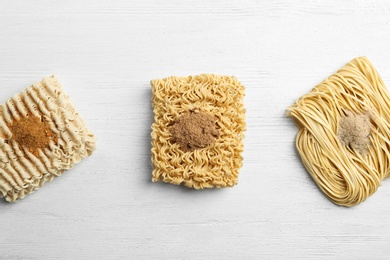 Photo of Flat lay composition with different quick cooking noodles on wooden background