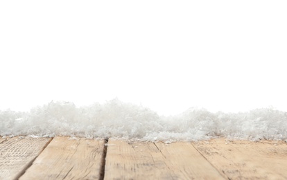 Photo of Snow on wooden surface against white background. Christmas season