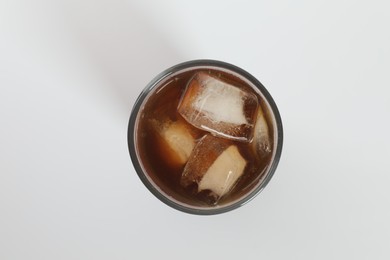 Photo of Iced coffee in glass on white background, top view