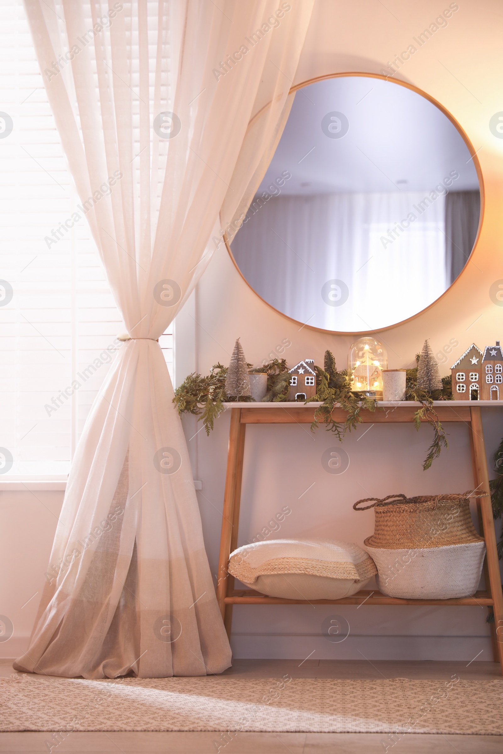 Photo of Stylish room interior with mirror and wooden console table near wall