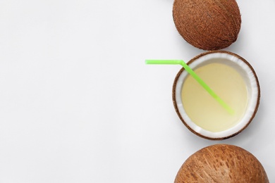 Photo of Composition with drink in half of coconut on white background, top view