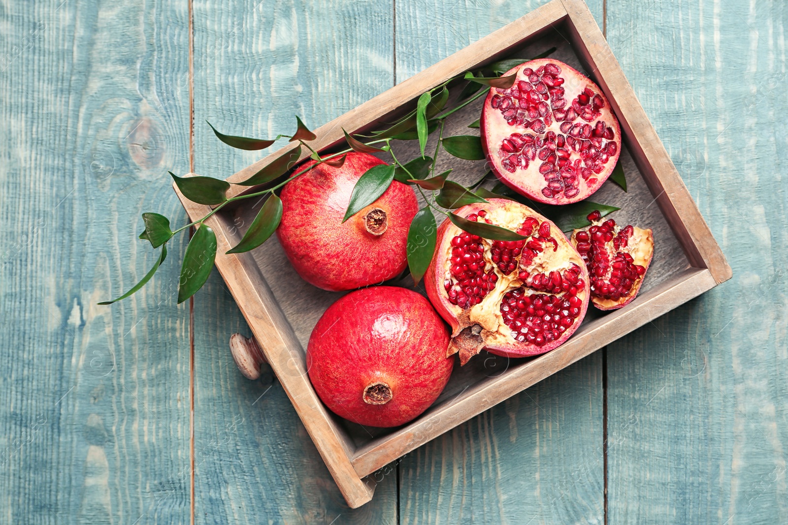 Photo of Drawer with pomegranates on wooden table